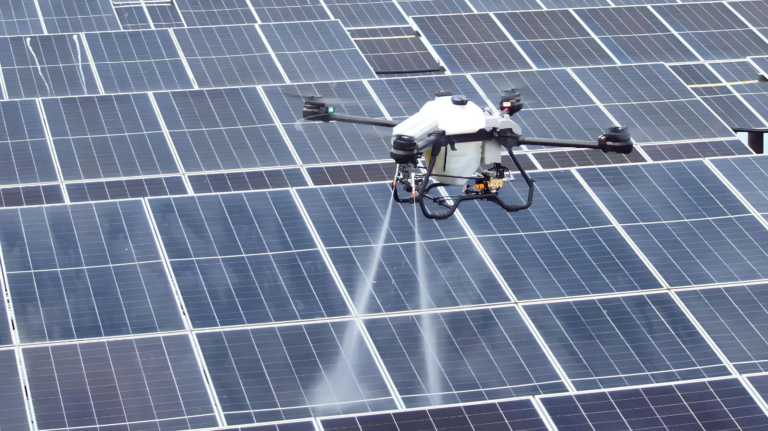 A drone cleaning a commercial rooftop solar array